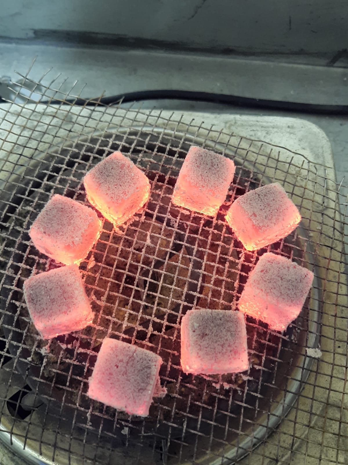 Pyramid stack of glowing charcoal briquettes