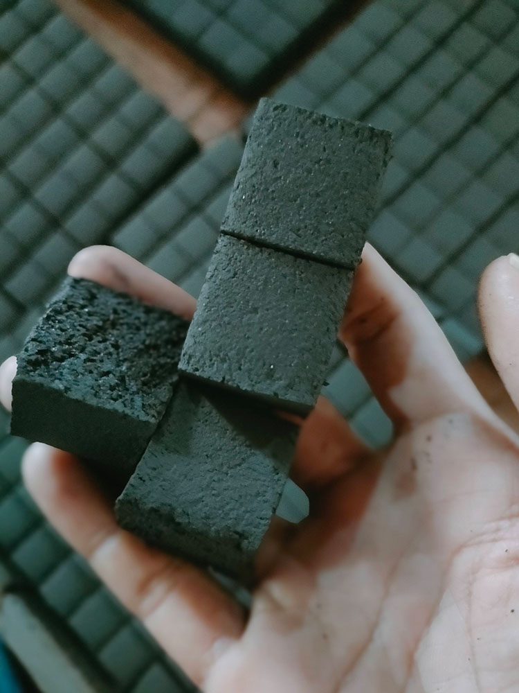 Raw unlit charcoal briquette pieces